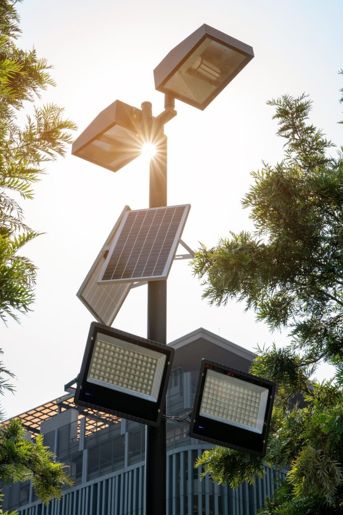 Solar Light. Public city light with solar panel powered on blue sky with clouds. Park public
